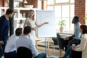 a sales trainer providing tips to a sales team at a business