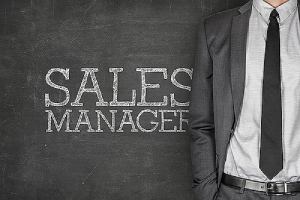 A man in business suit with sales manager written on the background. A concept for sales compensation consultant